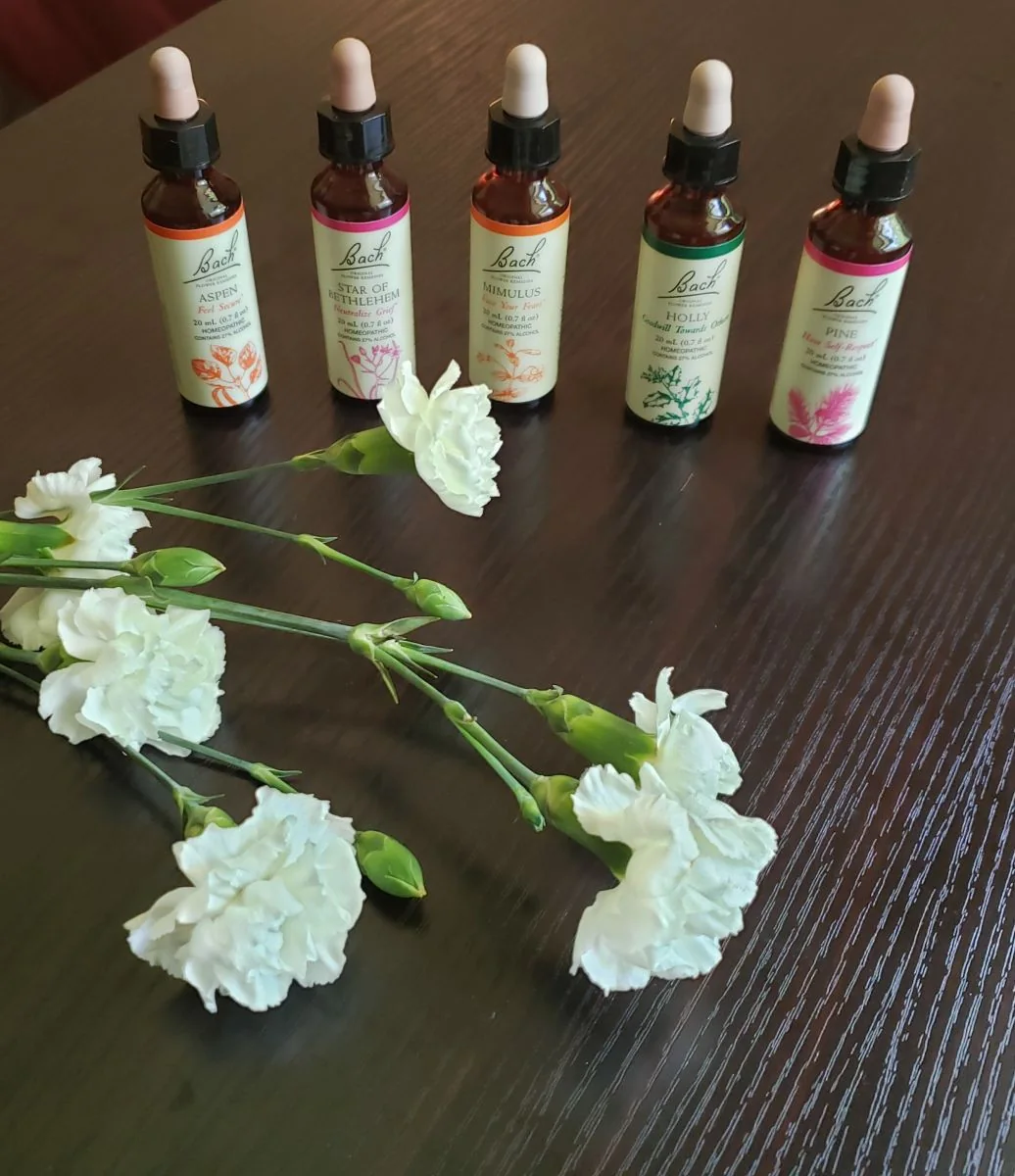 Bach flower remedy bottles with white carnations