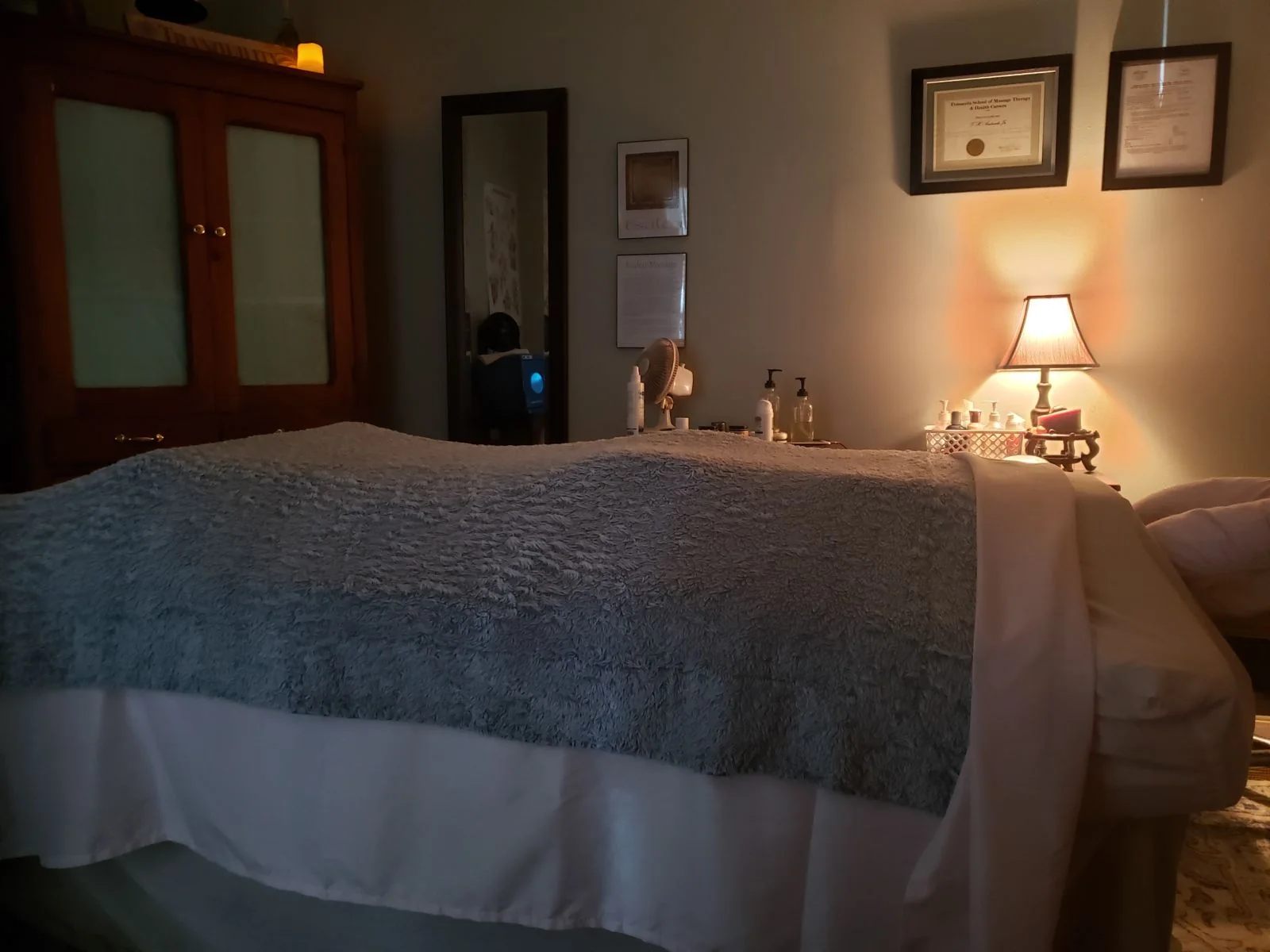 Heather's calm, softly lit treatment room with a massage table